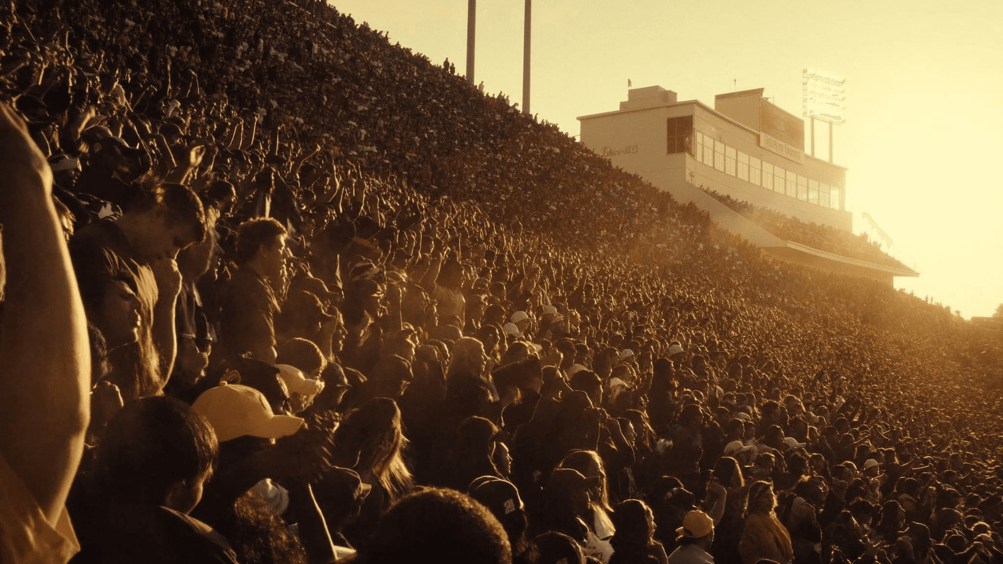College stadium crowd at golden hour